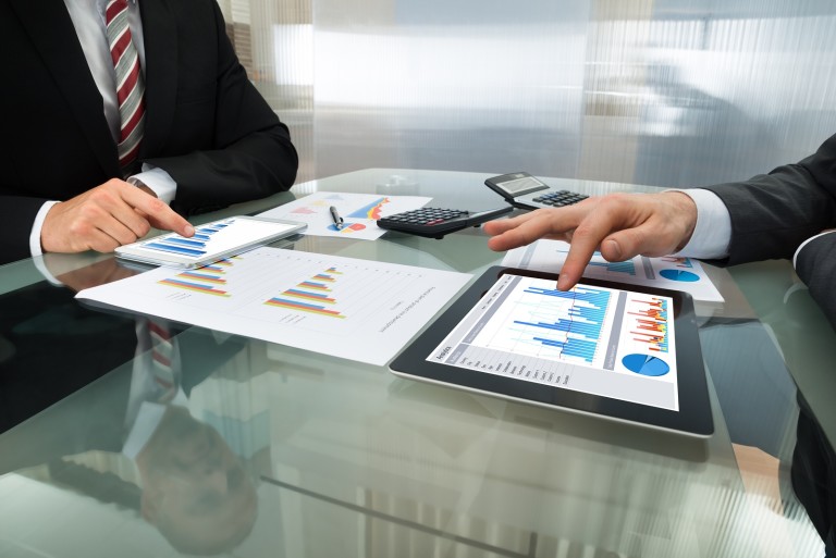 Two Businessman Working On Digital Tablet What Differentiates Lightle Beckner Robison, Inc. as a Market Leader in Commercial Real Estate in Brevard County and Florida?